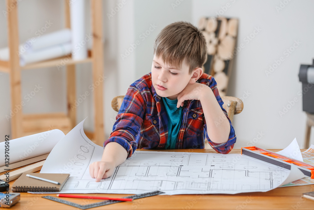 Cute little builder with drawings in room Cute little builder with drawings in room