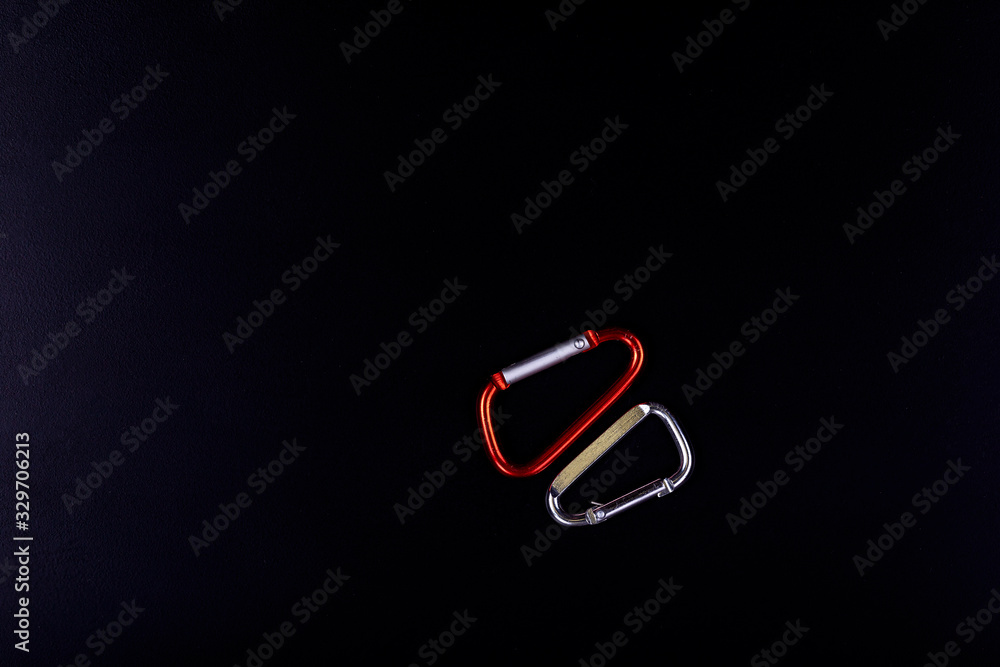 Carabiners for connecting various items and details on a black background. Carabiners for connecting various items and details on a black background.