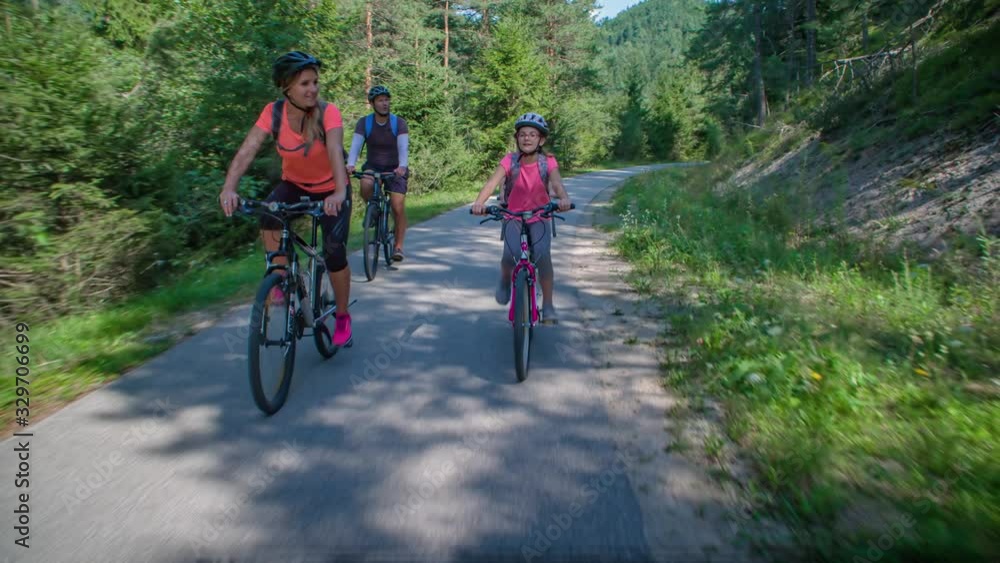 Caucasian lifestyle family ride bikes at park in Slovenia, slow motion Caucasian lifestyle family ride bikes at park in Slovenia, slow motion