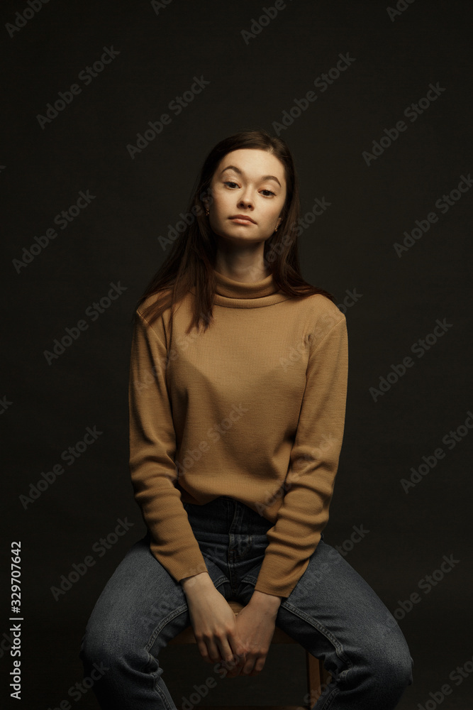 Professional model and posing. Model tests of a girl in a Studio with a black background.