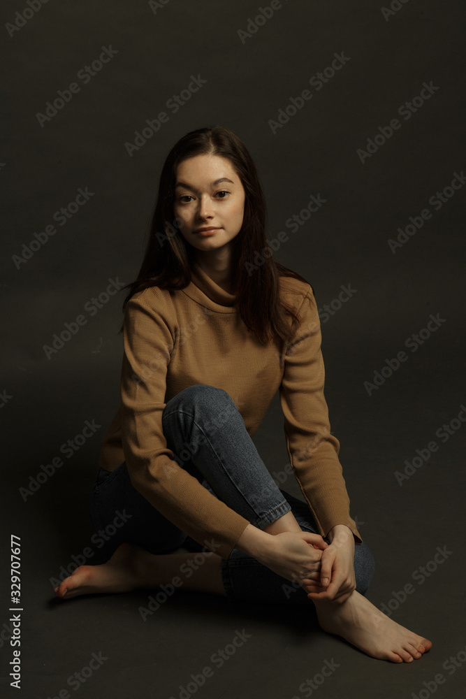 Professional model and posing. Model tests of a girl in a Studio with a black background. Professional model and posing. Model tests of a girl in a Studio with a black background.