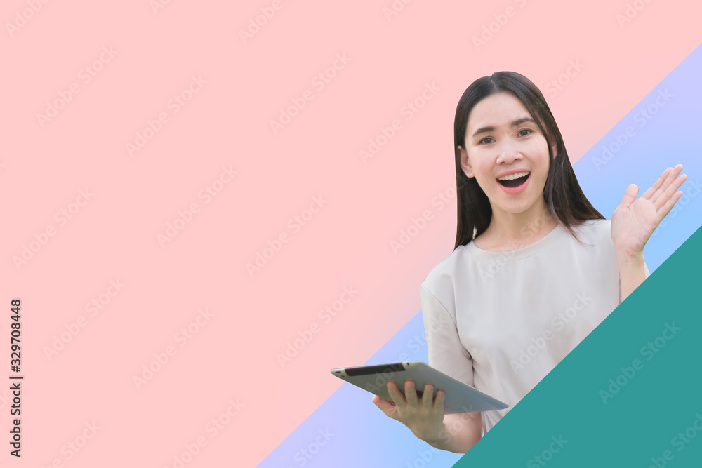 Women holding tablet feeling so happy Women holding tablet feeling so happy