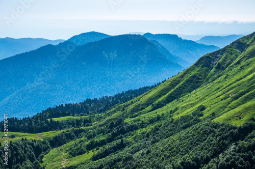 View over the Green Valley, surrounded by high mountains on a clear summer day