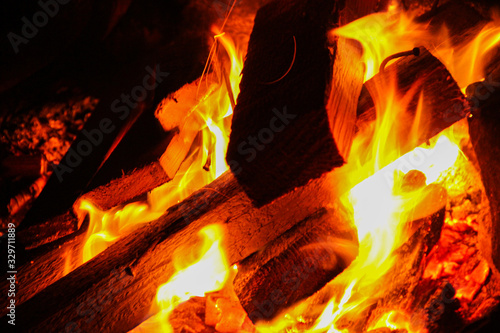 Macro shot of burning firewood with an open flame. Fire close