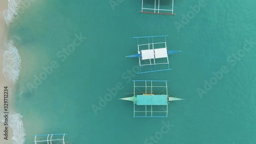 Traditional South East Asian Boats ona crystal clear blue water in Palawan, Philippines photo