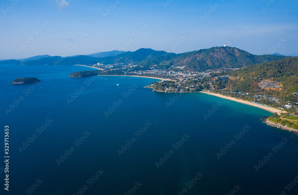 Aerial view of the coastline of Phuket island with tropical sandy beaches and mountains at sunny day, Thailand