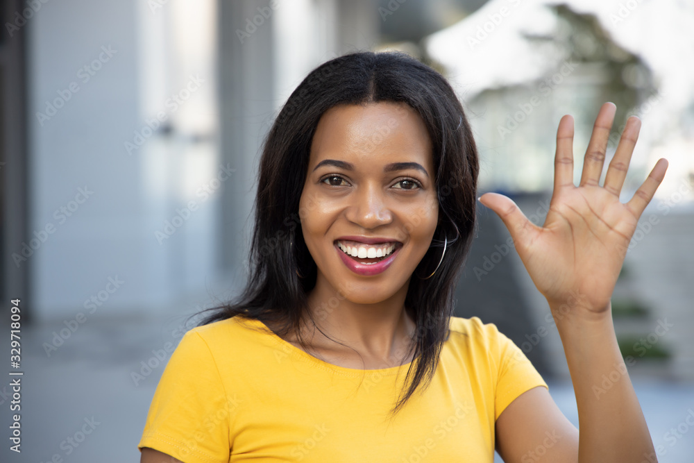 Black African woman pointing, counting five finger; portrait of positive happy smiling black African woman pointing up 5 fingers for number five or 5 points concept; Black African adult woman model