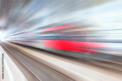 Red high speed train runs on rail tracks . Train in motion.