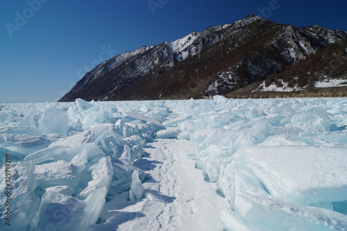 The surface of the lake is covered with huge blocks of ice to the horizon