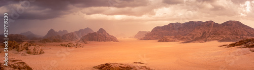 Wadi Rum desert in Jordan under dramtic rain and storm clouds. Panorama picture