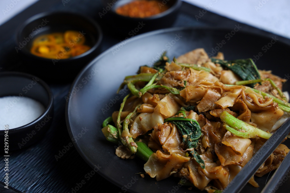 Thai food - Stir fried rice noodle with soy sauce. It’s called “Pad See Ew” in Thai language. Thai food - Stir fried rice noodle with soy sauce. It’s called “Pad See Ew” in Thai language.