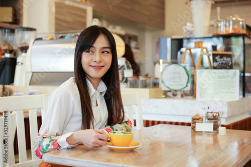 Beautiful asian woman eating delicious waffles in coffee shop cafe.