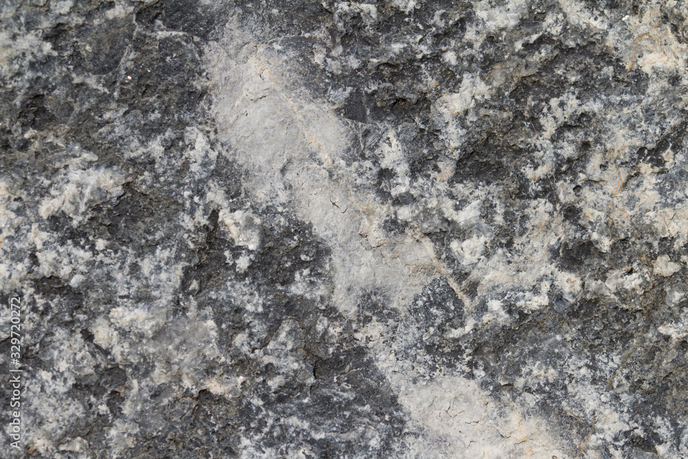 Surface grey granite stone with light lines and streaks. Surface grey granite stone with light lines and streaks.