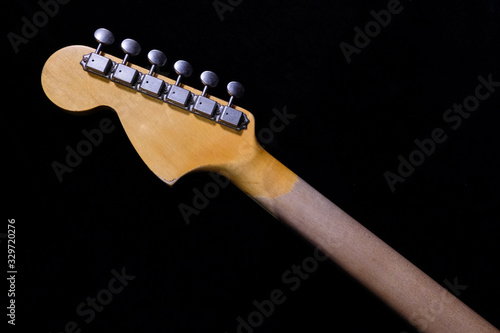 close up detail of electric guitar headstock, with selective focus.