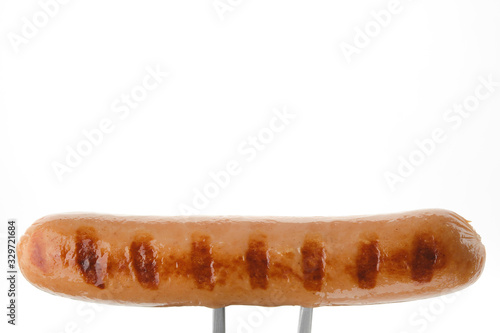 grill sausage on fork, white background