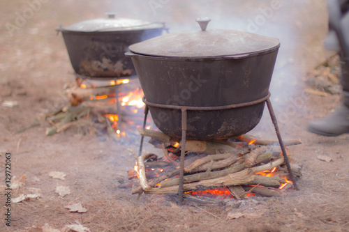 Cooking outdoors. Hike, picnic. Cauldron on an open fire.