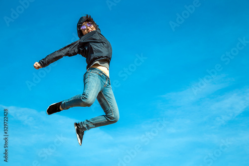 hapy jumping asian woman on clear sky with active