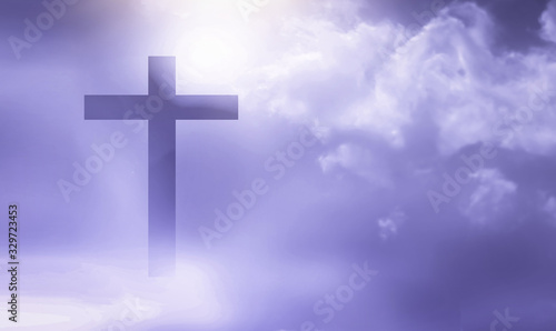 Christian cross appeared bright in the sky with soft fluffy clouds, white, beautiful colors. With the light shining as hope, love and freedom in the sky background