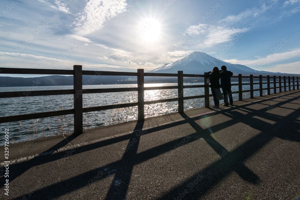 Beautiful silhouette view of two travellers taking a photo of Mount Fuji at Fujiyoshida, japan.