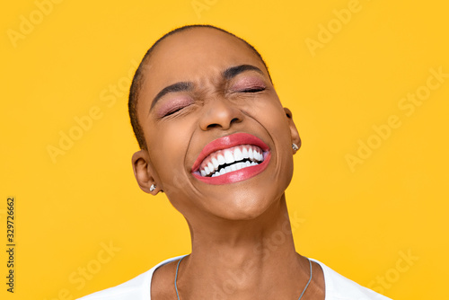 Fotografija Happy ecstatic African American woman smiling with eye closed isolated on colorf