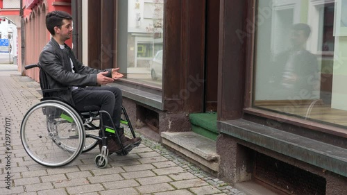 a man in a wheelchair cannot drive into a small shop