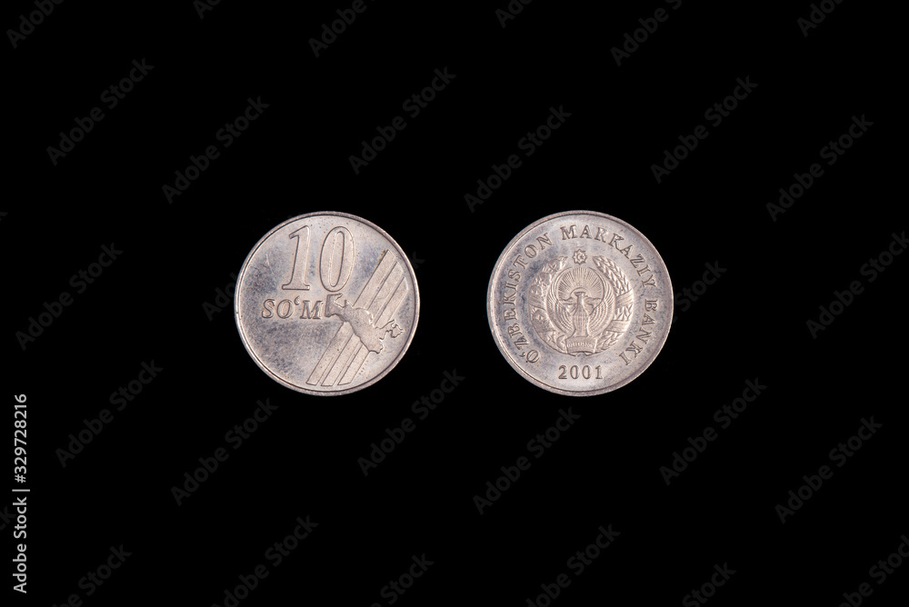 10 Uzbek som coin 2001 on a black background. close-up on both sides 10 Uzbek som coin 2001 on a black background. close-up on both sides