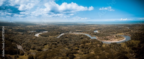Panoramic shot of a curvy river in the middle of trees in Papua New Guinea