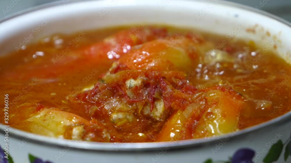 Homemade stuffed peppers boiling in soup pot on stove Homemade stuffed peppers boiling in soup pot on stove