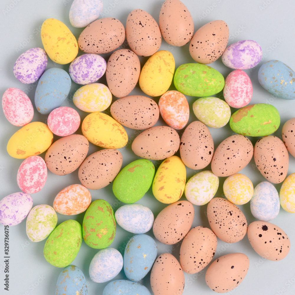 Pattern made of colorful easter eggs on a blue pastel background. Holiday creative concept. Pattern made of colorful easter eggs on a blue pastel background. Holiday creative concept.