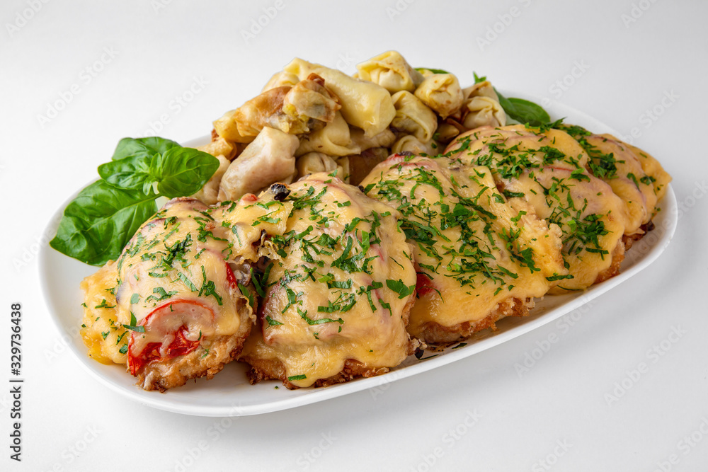 Meat chop with vegetables in egg batter with flour and noodles and mushrooms. Banquet festive dishes. Gourmet restaurant menu. White background. Meat chop with vegetables in egg batter with flour and noodles and mushrooms. Banquet festive dishes. Gourmet restaurant menu. White background.