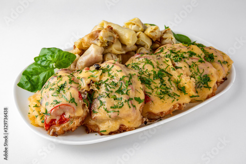 Meat chop with vegetables in egg batter with flour and noodles and mushrooms. Banquet festive dishes. Gourmet restaurant menu. White background.