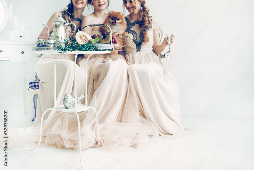 bride and her friends sitting in a stylish boudoir.