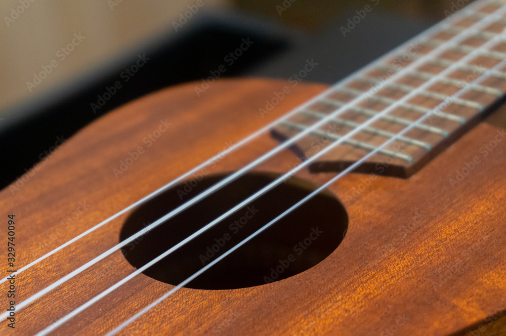 Fototapeta premium Instrument Hawaii ukelele made of wood with wood pattern on the table in the house