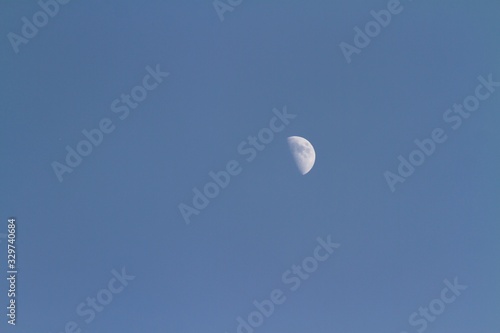 Glowing moon in sky background at dusk