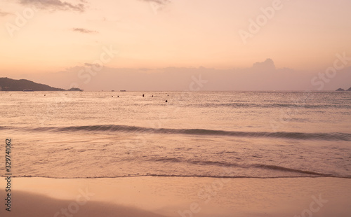 Panorama of Patong beach and Andaman sea on Phuket in Thailand during sunset. Pink and gold colors  view of the hills