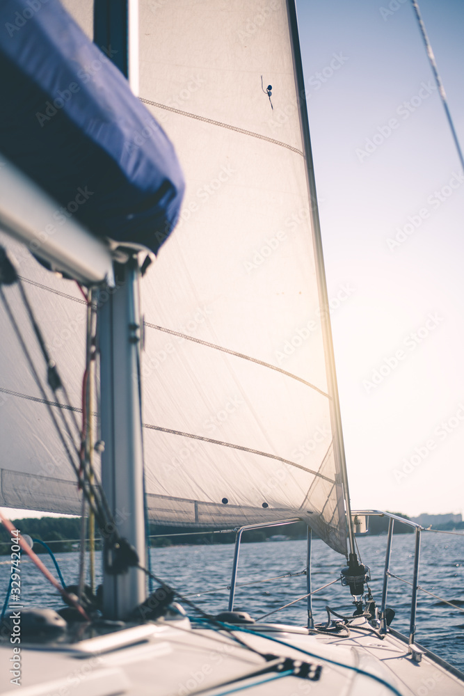 Obraz premium White cloth fabric, masts and ropes close-up on sail of tri-yacht or yacht sailing boat