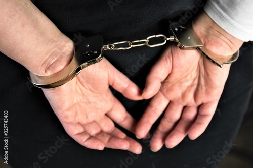 hands of man and woman in handcuffs