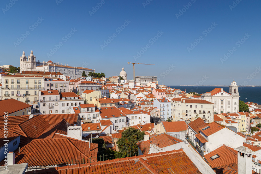 Church of Sao Vicente of Fora (Igreja de Sao Vicente de Fora), old buildings in Alfama and Graca districts and Tagus River in Lisbon, Portugal.
