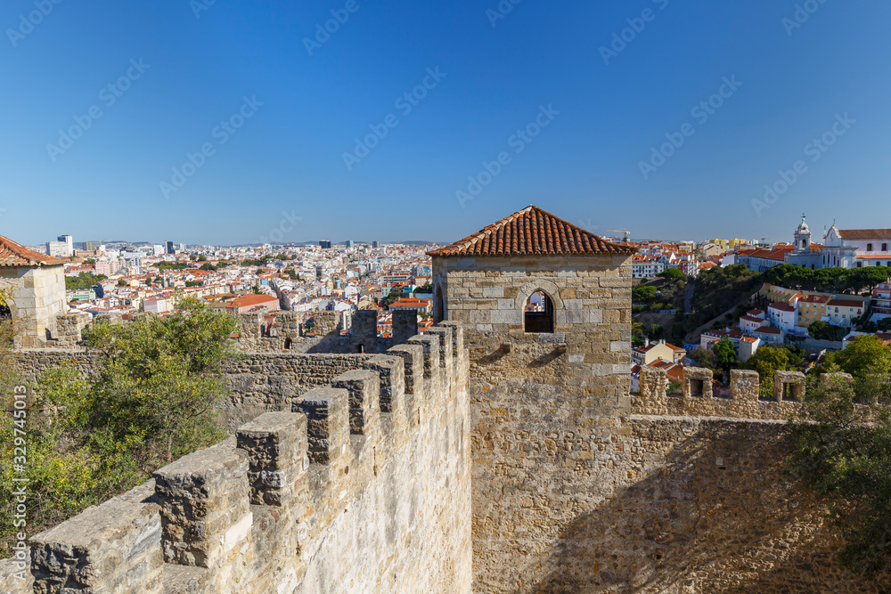 Historical Sao Jorge Castle (Saint George Castle, Castelo de Sao Jorge) and view of the Lisbon city in Portugal, on a sunny day in the summer. Historical Sao Jorge Castle (Saint George Castle, Castelo de Sao Jorge) and view of the Lisbon city in Portugal, on a sunny day in the summer.