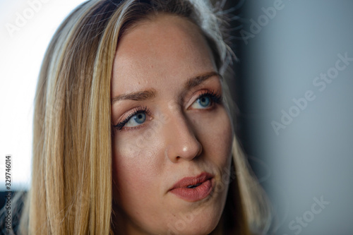 Close up portrait of blonde female with blue eyes