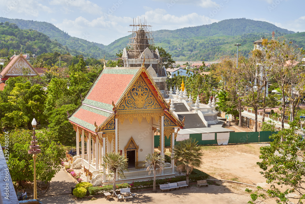 Wat Chalong or Chayatararam is Buddhist temple complex on island of Phuket in country of Thailand. Photo taken on February 23, 2020. lush green garden plants spread trees