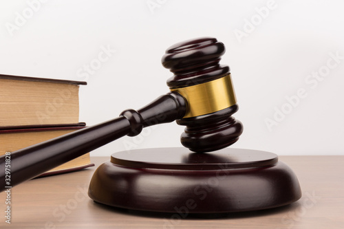 Wooden judges gavel on wooden table, close up. Space for text