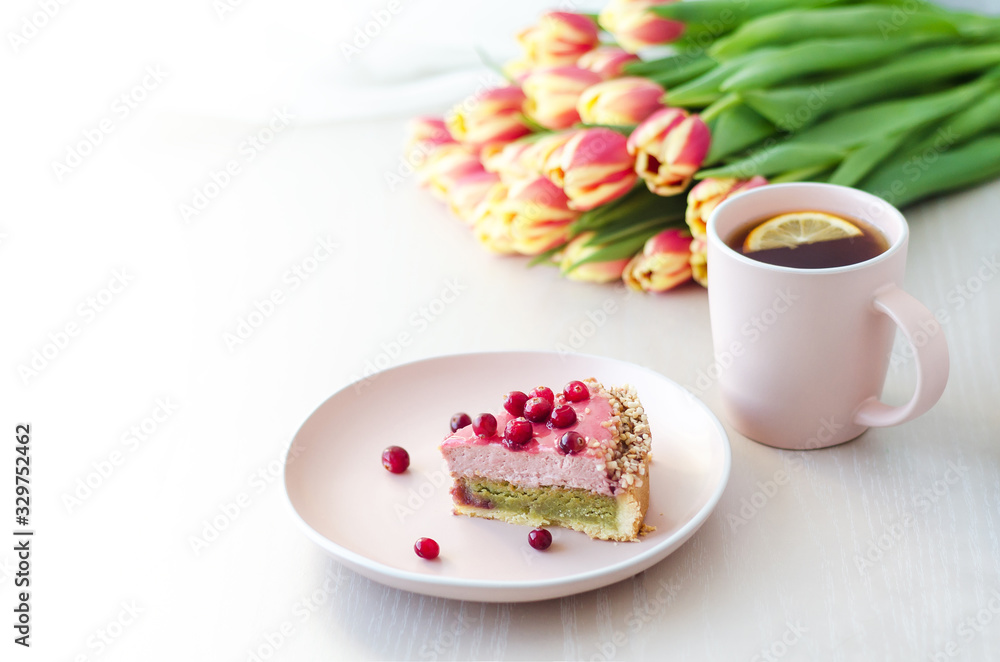 breakfast, holiday, morning with flowers tulips, cake, tea, coffee in pink mug on light background. women’s, mother’s, Valentine's Day, birthday. copy space, soft focus