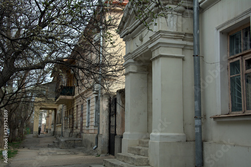 entrance to an old house with square columns © Yury