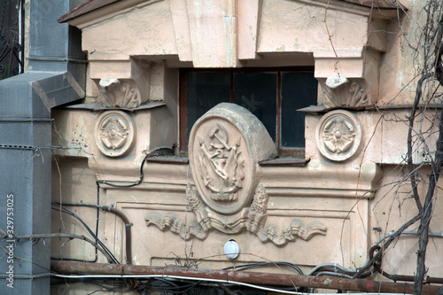 viewing window of an old house with stucco decorations