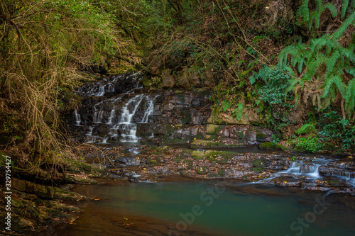 waterfall small cover with green forest long exposure flat angle image