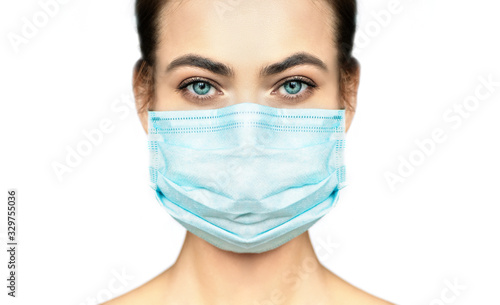 Cropped image of beautiful woman in protection medical mask.