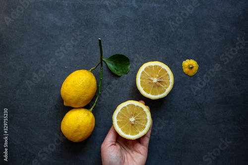 Fresh yellow lemon on dark gray background.