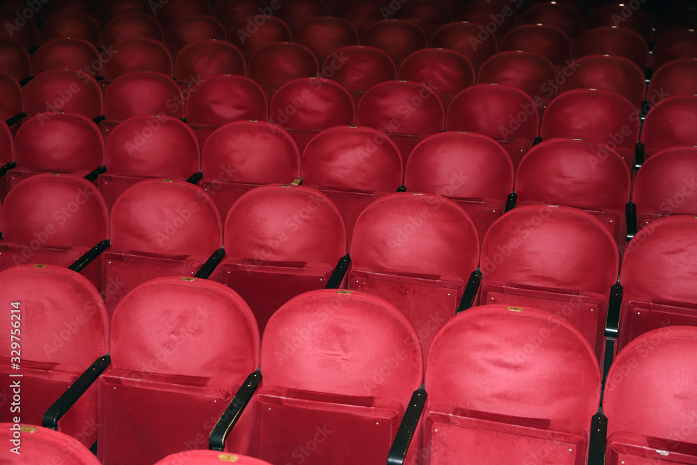 Naklejka premium Classic rows of empty reddish seats in theatre
