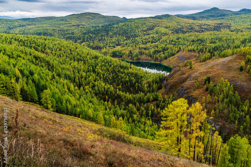View of Lake Uchkol. Autumn taiga landscape. Ulagansky District, Altai Republic, Russia